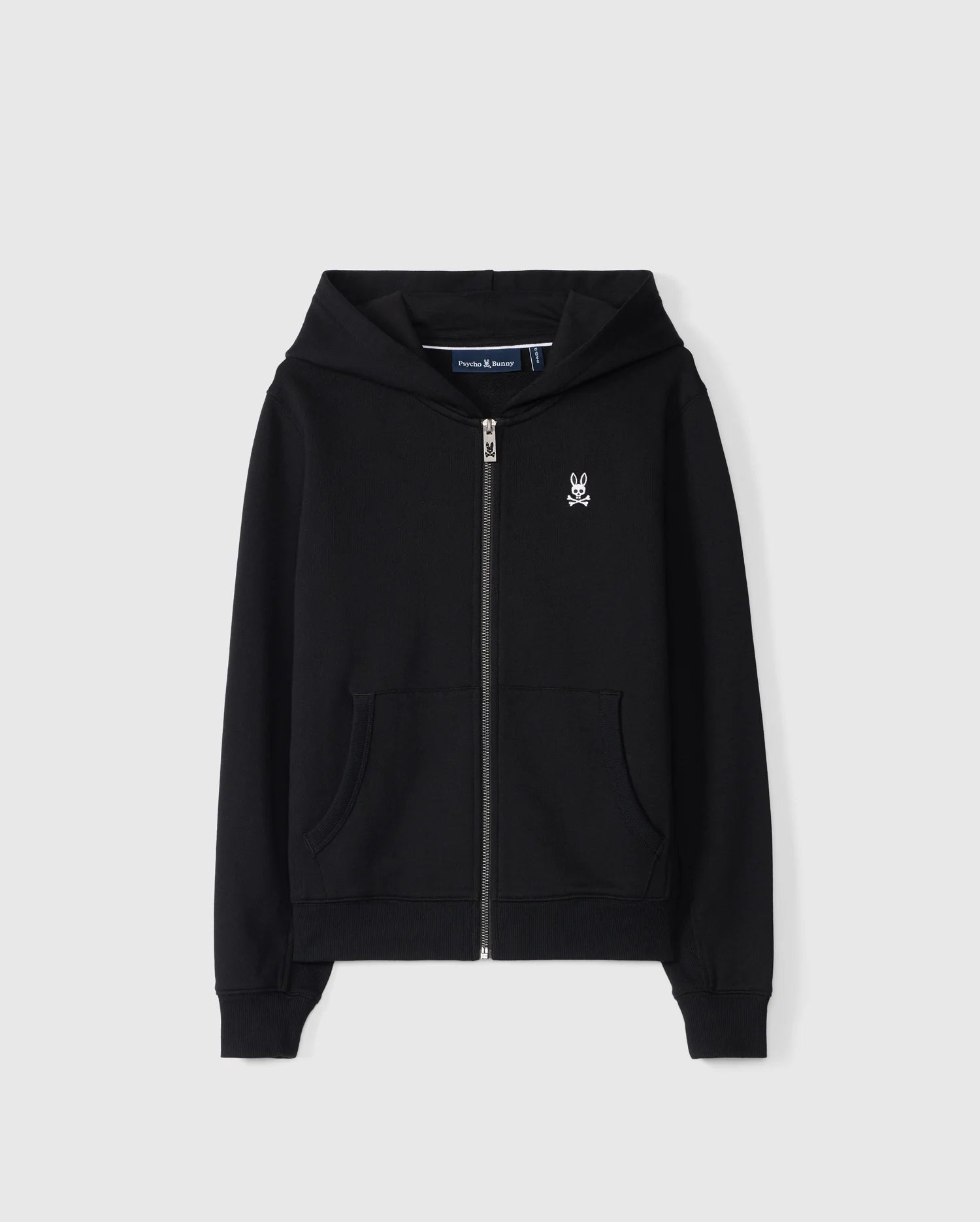 The KIDS LEVY ZIP FLEECE HOODIE - B0H720D200 by Psycho Bunny features a black zip-up design with a small white bunny logo on the left chest. Constructed from 100% cotton French terry, it includes front pockets and a hood, showcased against a plain white background.