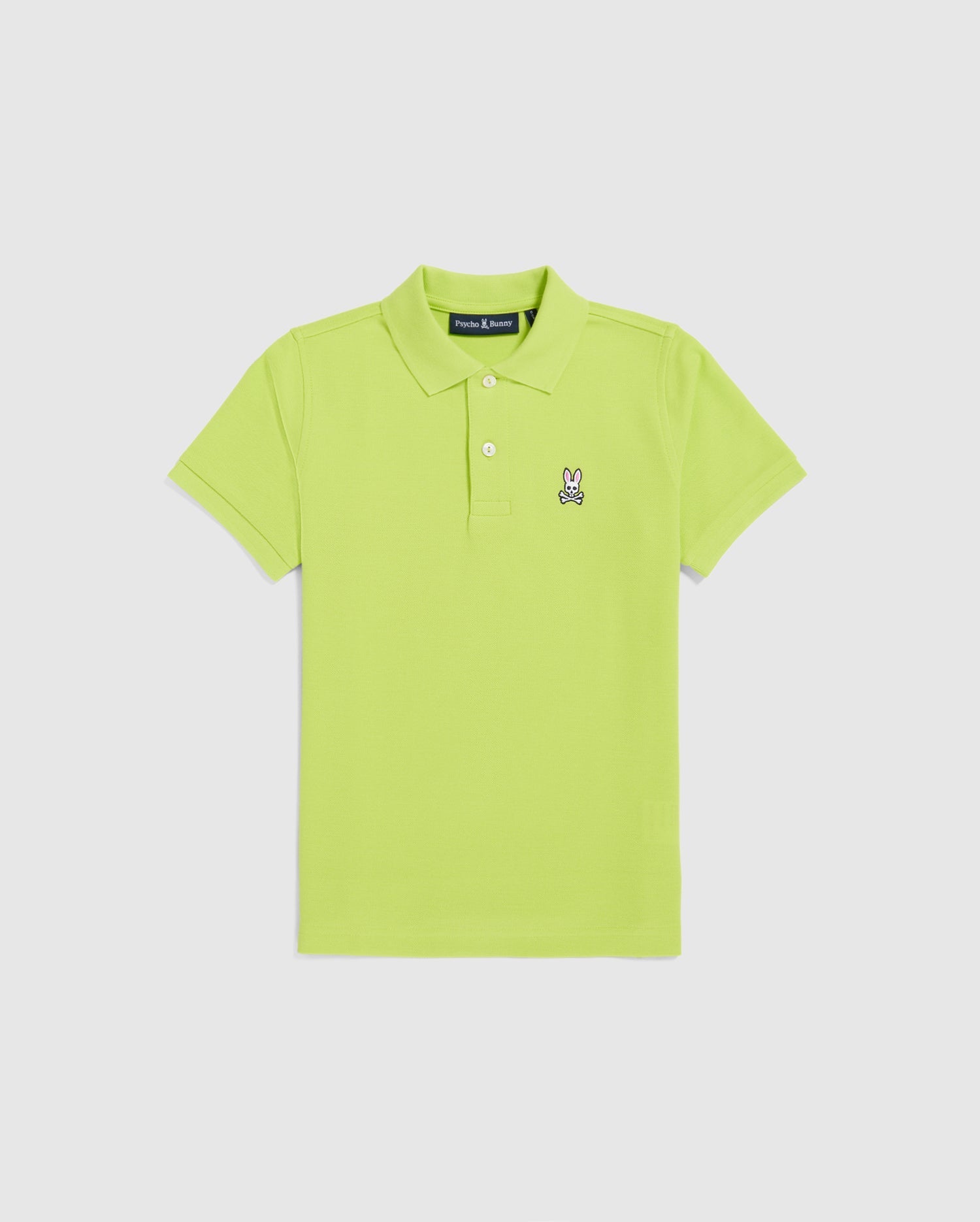 The Psycho Bunny KIDS CLASSIC POLO - B0K001CRPC is a bright green, short-sleeved polo for kids, made from Pima cotton with a collar. It features an embroidered cartoon bunny on the left chest, showcasing classic piqué style. The shirt is displayed flat on a plain white background.