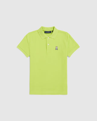 The Psycho Bunny KIDS CLASSIC POLO - B0K001CRPC is a bright green, short-sleeved polo for kids, made from Pima cotton with a collar. It features an embroidered cartoon bunny on the left chest, showcasing classic piqué style. The shirt is displayed flat on a plain white background.