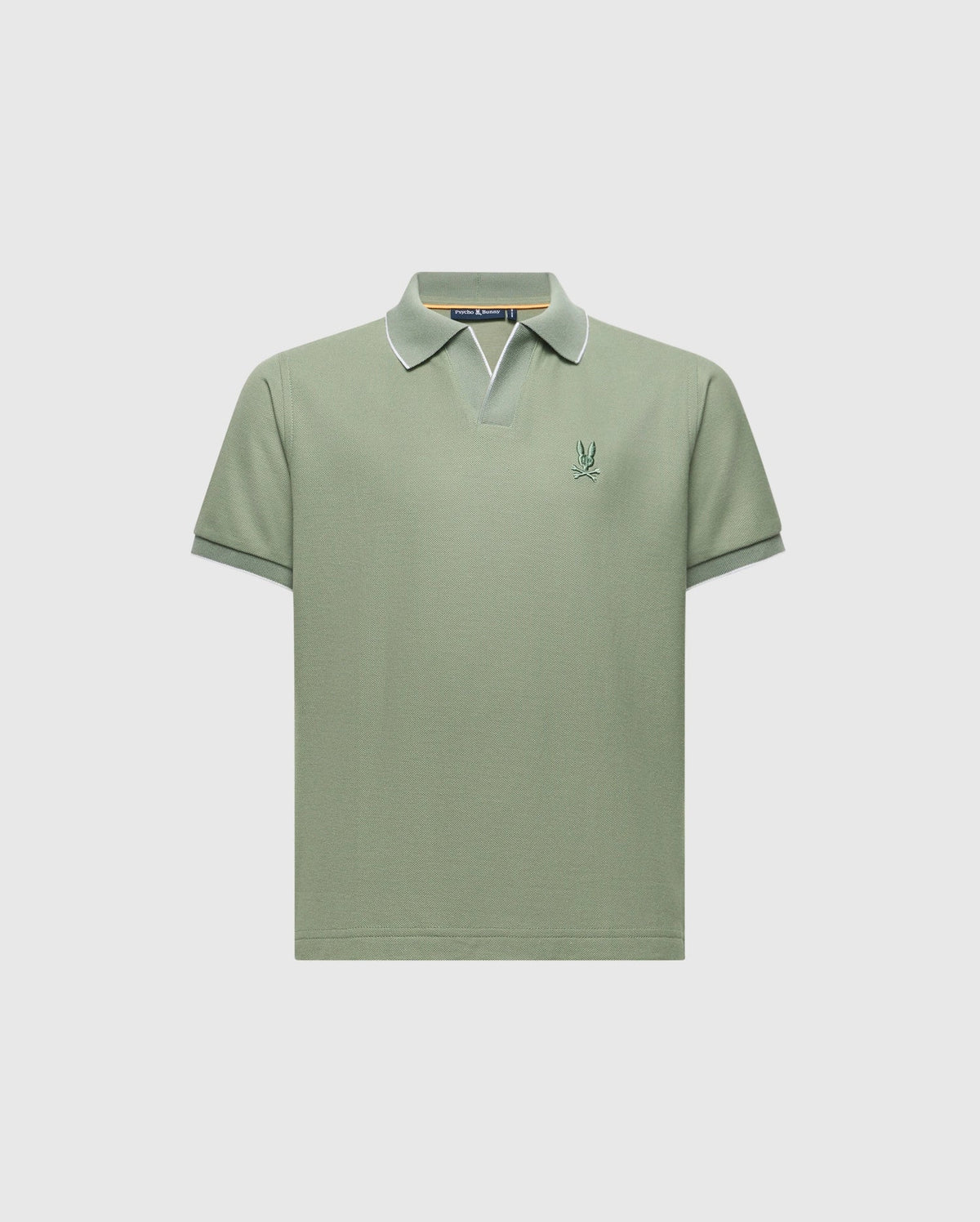 The KIDS EAST HILLS JOHNNY COLLAR POLO - B0K331B200 by Psycho Bunny is a light green, 100% Pima cotton short-sleeve shirt with a Johnny collar featuring white edging and a small embroidered logo on the left chest, exuding a seaside vibe against a plain white background.