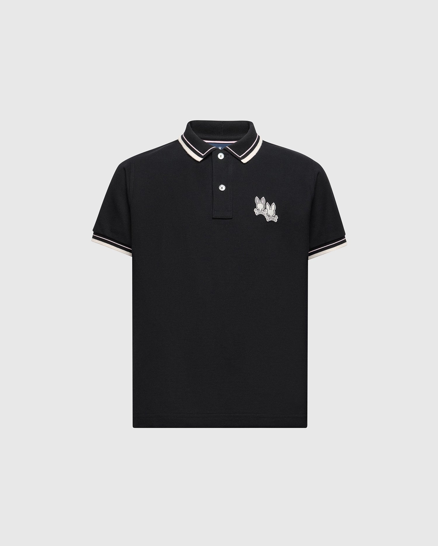 The KIDS ELLIOT PIQUE POLO - B0K505F200 by Psycho Bunny is a black polo made from soft Pima cotton, highlighted with white and tan trim on the collar and sleeves, featuring a playful embroidered Bunny on the left chest, elegantly displayed against a light gray background.