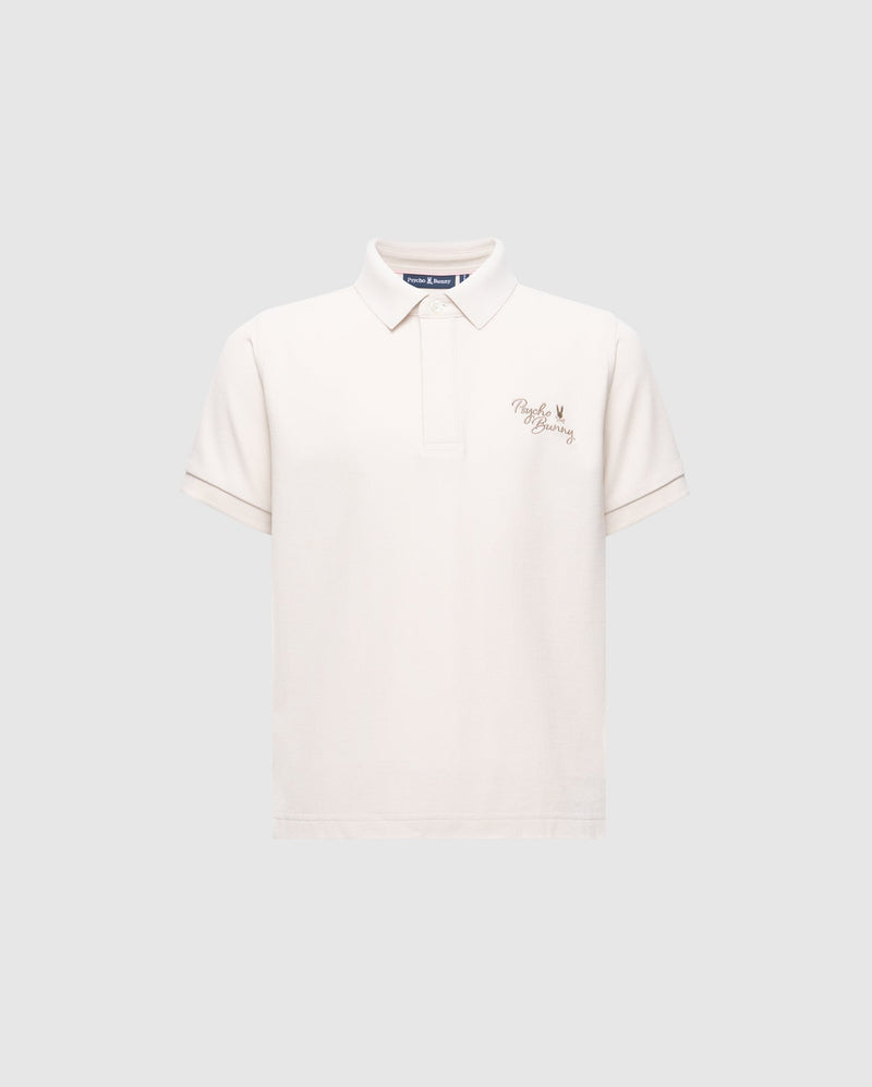 The Psycho Bunny KIDS DESERT PIQUE POLO - B0K506F200 is a classic, gray Pima cotton shirt with a collar, short sleeves, and features an embroidered crown and "Polo Factory" on the left chest for a timeless look.