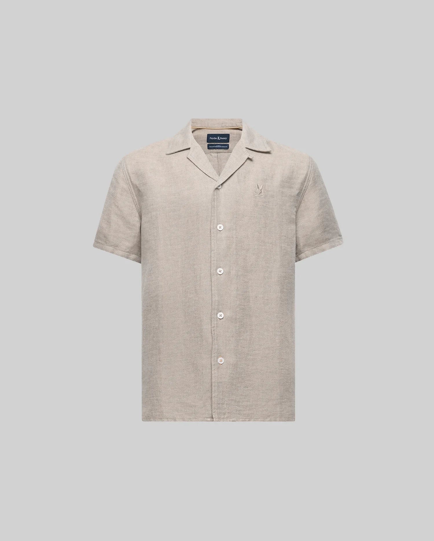 The Psycho Bunny KIDS WINDCREST LINEN BLEND SHORT SLEEVE SHIRT (B0Q148C200) is a light beige button-up with an open spread collar, mother-of-pearl buttons, chest logo embroidery, and is made from a soft linen-cotton blend.