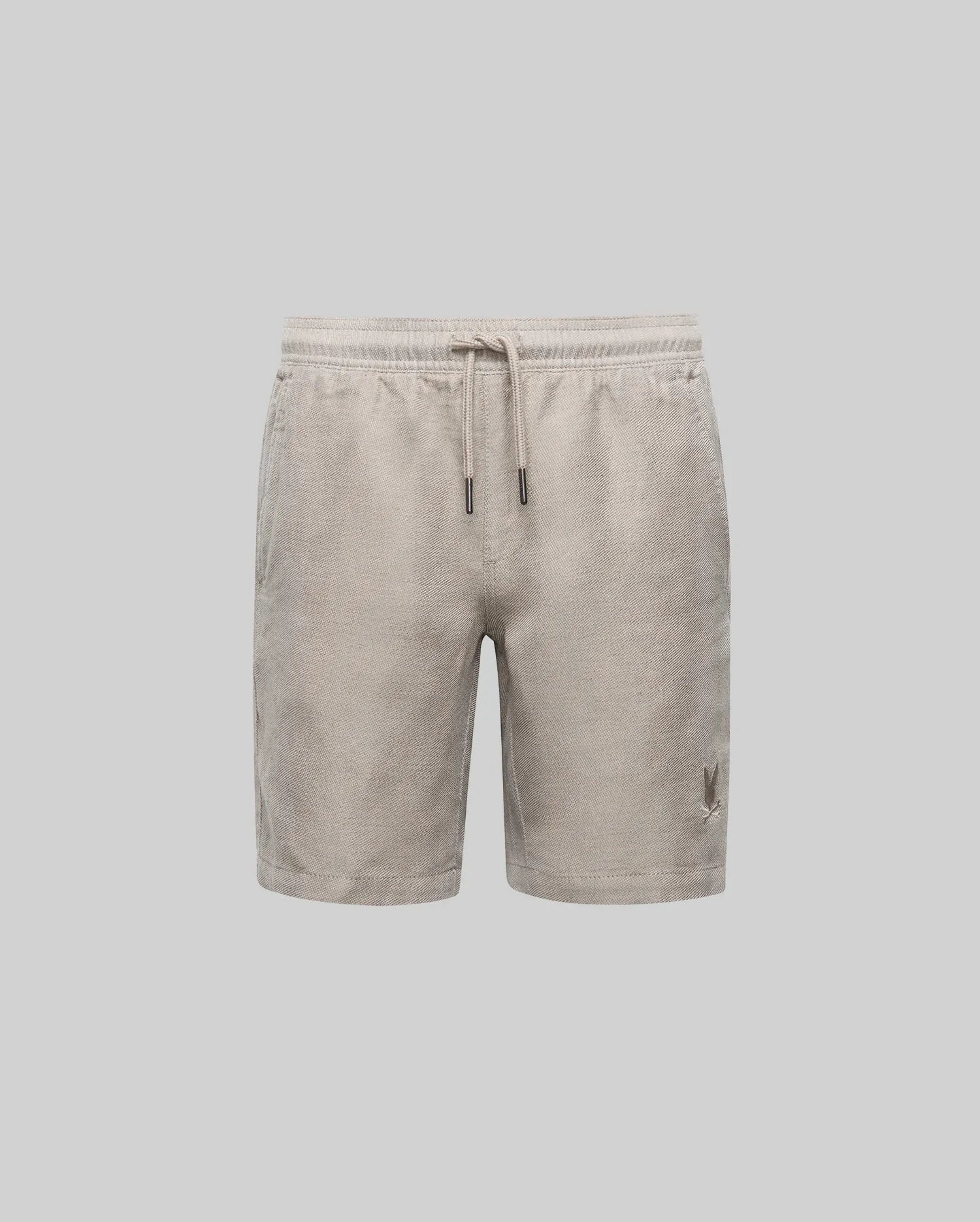 Psycho Bunny KIDS beige corduroy shorts with an elastic drawstring waist and small embroidered logo on the lower left leg, shown on a plain light gray background.