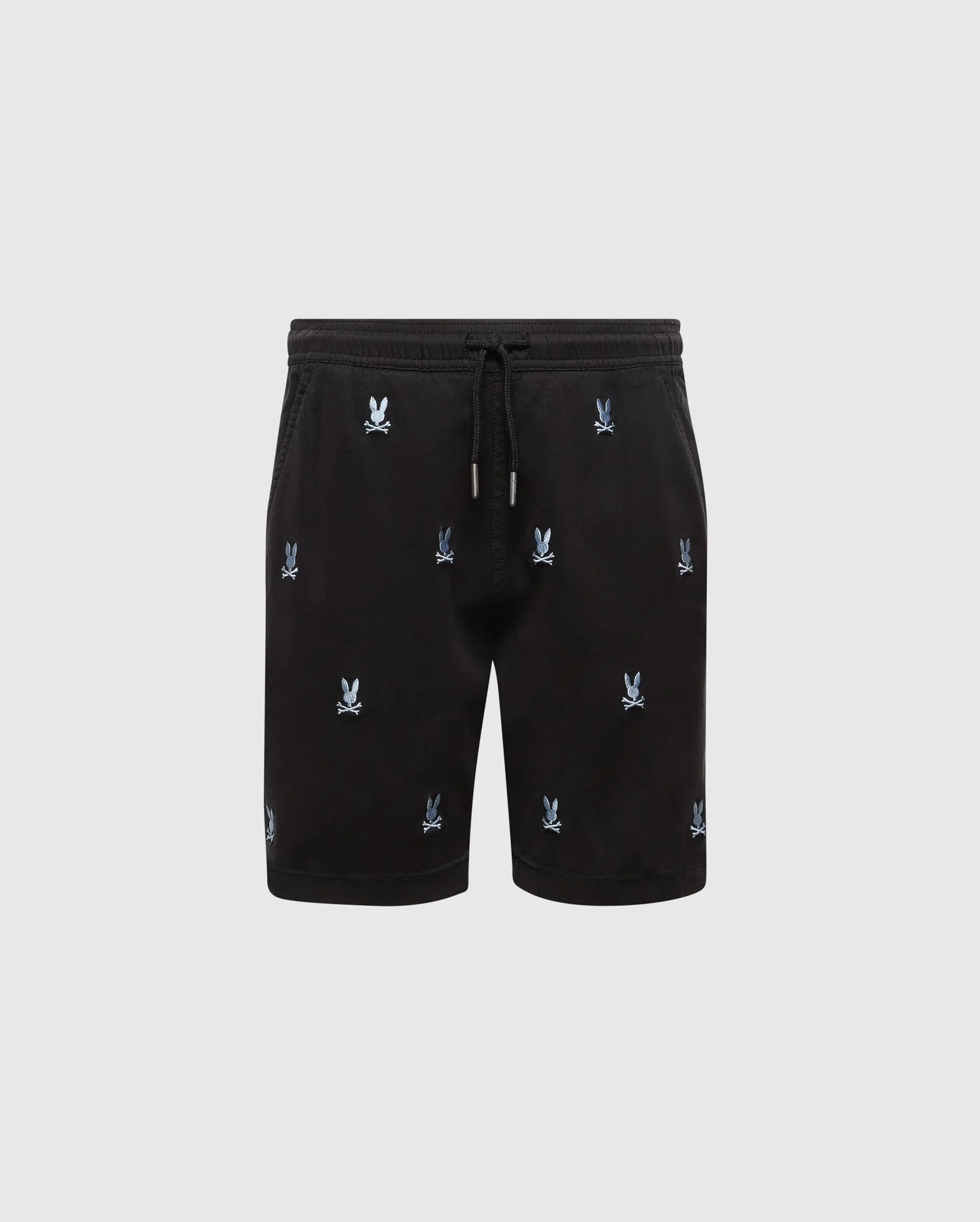 The KIDS ALL OVER WILLIS STRETCH TENCEL SHORT by Psycho Bunny features black drawstring shorts with an elastic waist and an all-over light blue Bunny logo pattern, shown on a plain light gray background.