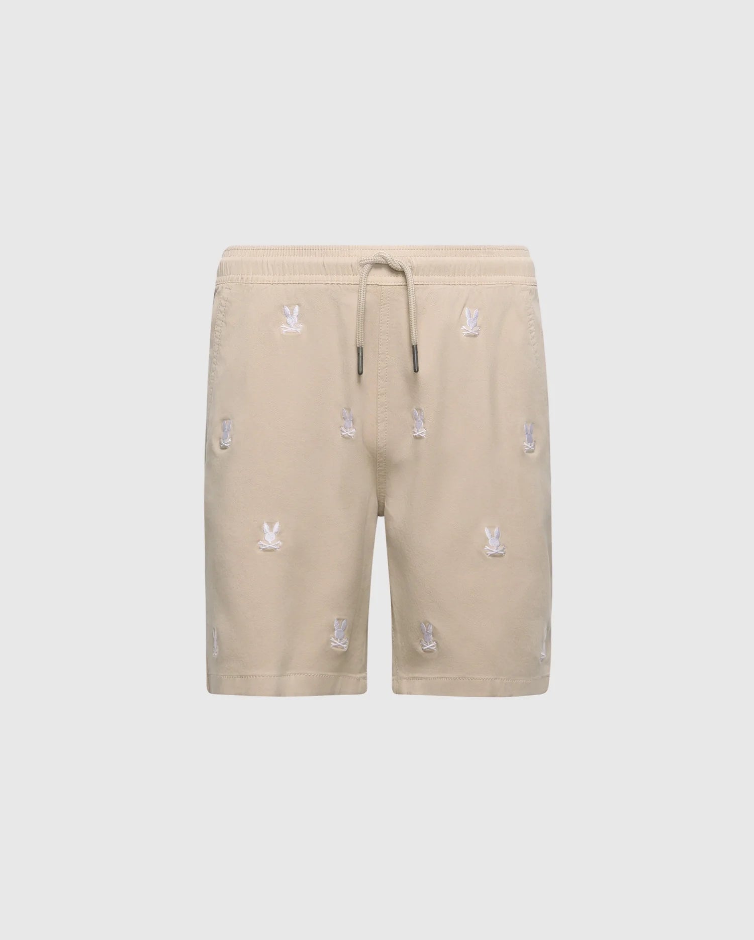 The KIDS ALL OVER WILLIS STRETCH TENCEL SHORT by Psycho Bunny, B0R559F200, features beige fabric with an elastic waistband, drawstring, and small white embroidered motifs. Its stretch Tencel blend offers comfort and sophistication against a plain white background.