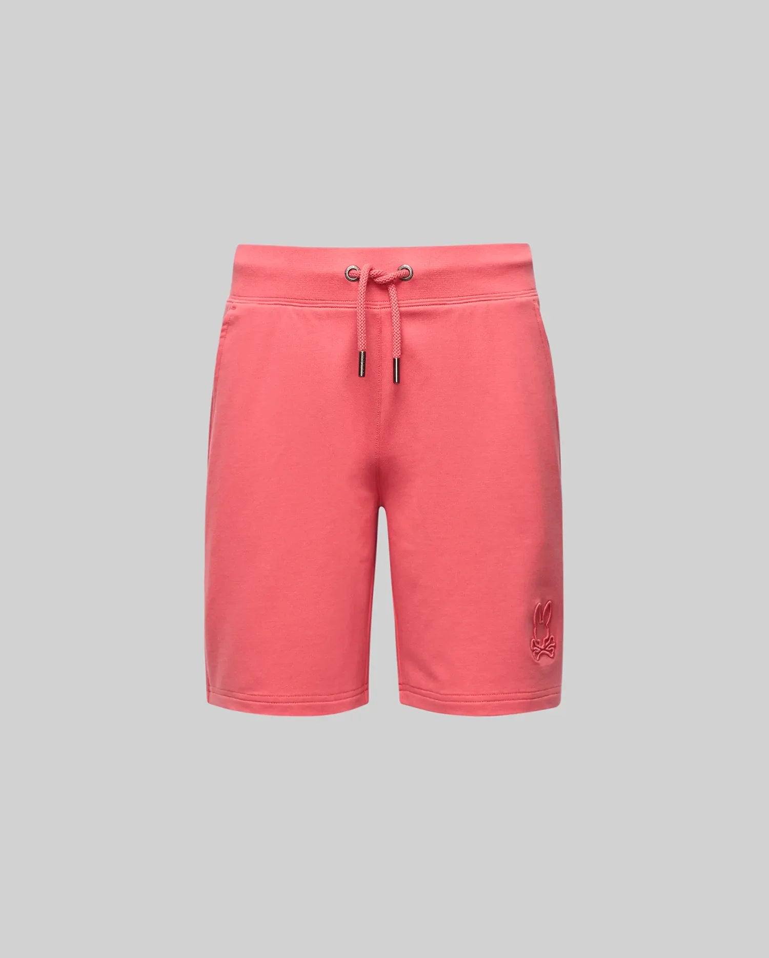The Psycho Bunny KIDS LEVANZO EMBROIDERED MICRO FRENCH TERRY SWEATSHORT (B0R578F200) in coral pink offers luxury comfort, metal eyelets, and a subtle hem logo, shown against a plain light gray background.