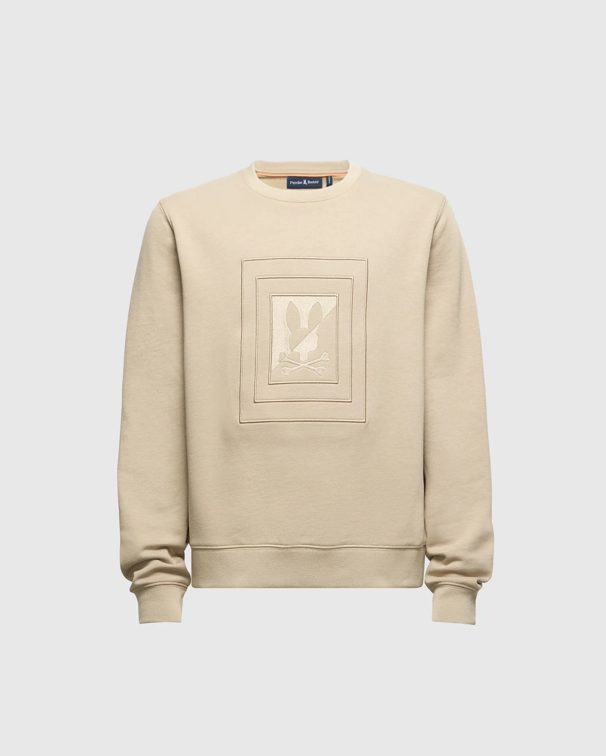 Introducing the KIDS OAK CITY CREW NECK SWEATSHIRT by Psycho Bunny - B0S274E200. This beige sweatshirt is crafted from lightweight materials and showcases a central square embroidered design with abstract shapes. Featuring long sleeves and a classic crew neck, it is displayed against a simple light gray backdrop.