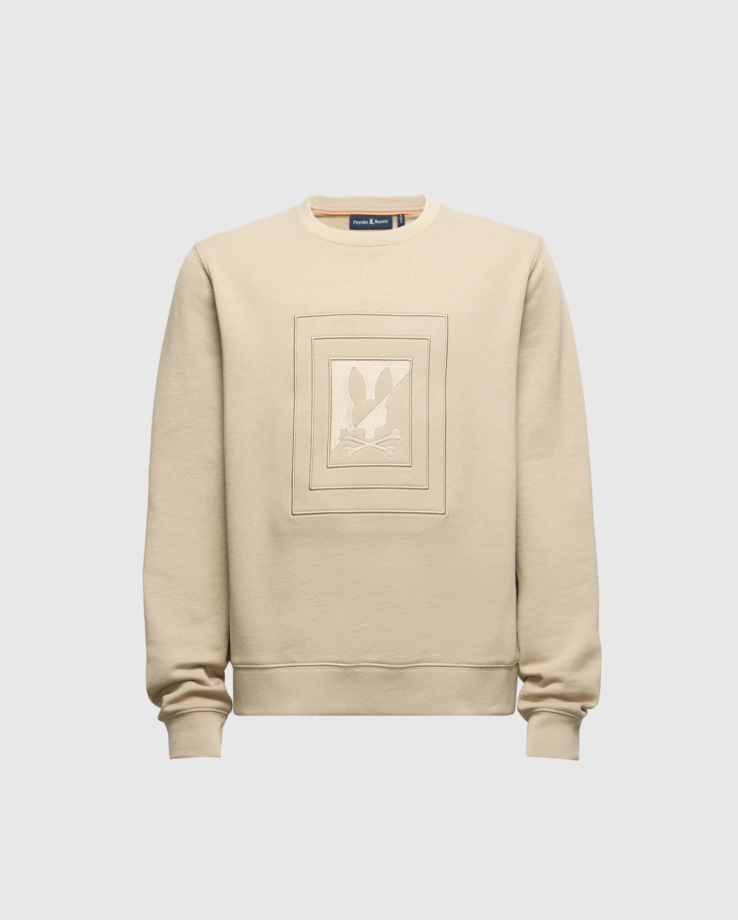 Introducing the KIDS OAK CITY CREW NECK SWEATSHIRT by Psycho Bunny - B0S274E200. This beige sweatshirt is crafted from lightweight materials and showcases a central square embroidered design with abstract shapes. Featuring long sleeves and a classic crew neck, it is displayed against a simple light gray backdrop.
