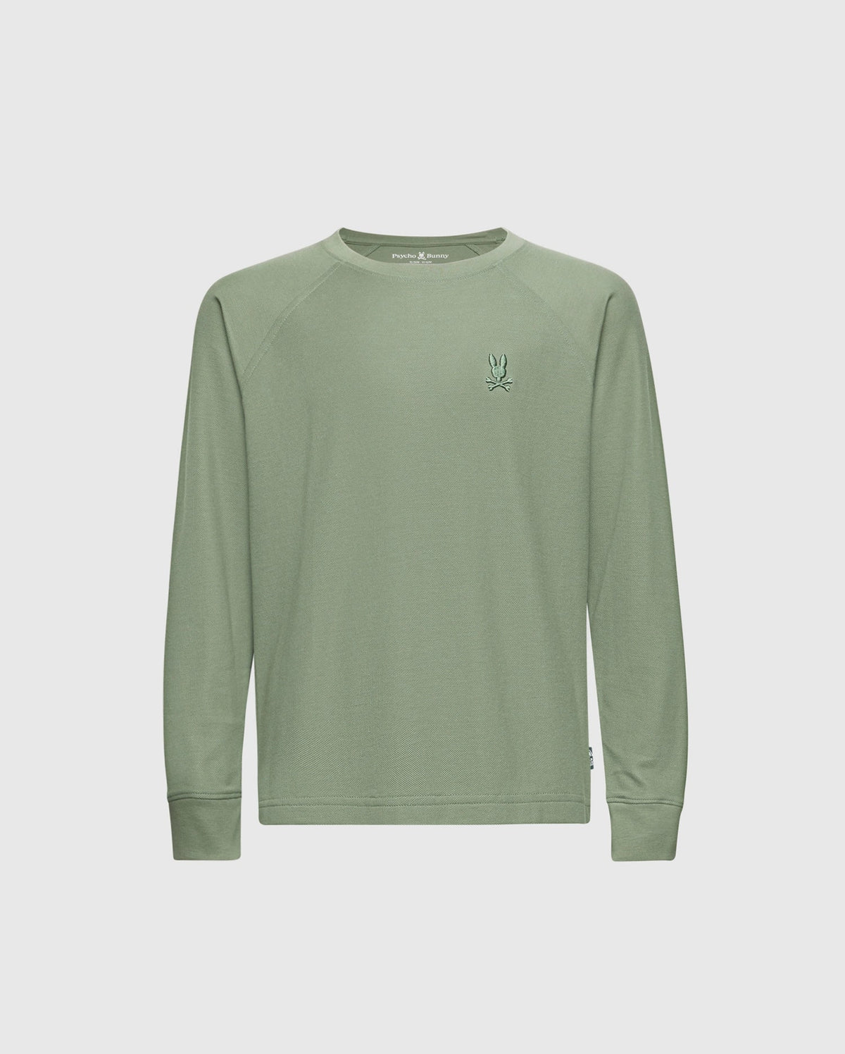 The KIDS TAYLOR PIQUE LONG SLEEVE TEE (B0T580F200) by Psycho Bunny is a pale green crewneck shirt made from soft Pima cotton. It has a small embroidered bunny logo on the left chest, offers a relaxed fit, and is shot against a white background without extra patterns or embellishments.