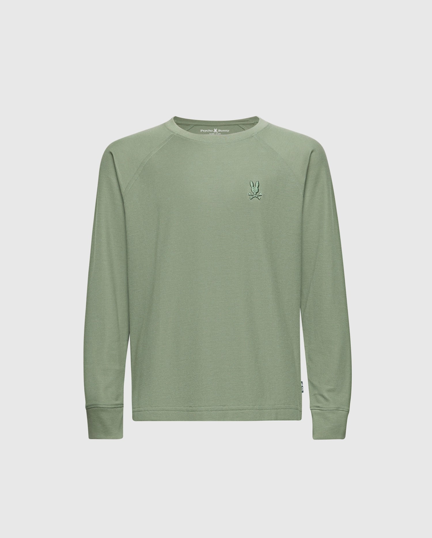 The KIDS TAYLOR PIQUE LONG SLEEVE TEE (B0T580F200) by Psycho Bunny is a pale green crewneck shirt made from soft Pima cotton. It has a small embroidered bunny logo on the left chest, offers a relaxed fit, and is shot against a white background without extra patterns or embellishments.