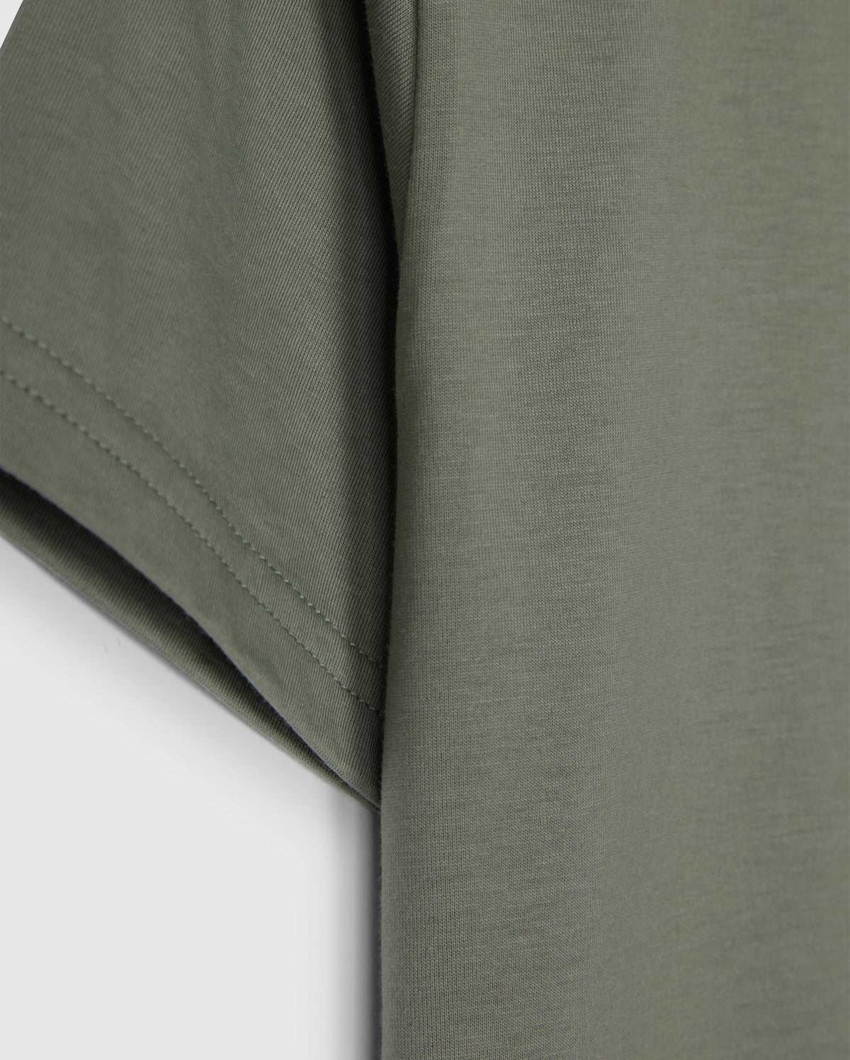 The KIDS CLASSIC CREW NECK TEE - B0U014B200 by Psycho Bunny, in olive green, showcases sleeve and side details on a plain white background. Made from 100% Pima cotton, its texture and stitching make it an ideal back-to-school choice.