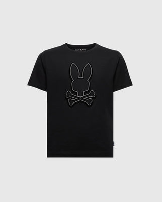 The KIDS ALEXANDER GRAPHIC TEE - B0U163E200 by Psycho Bunny is a premium quality black T-shirt made from soft Pima Cotton, showcasing a stylish design of a bunny head above crossed bones in dark gray. This kids' graphic tee stands out against a light gray background.