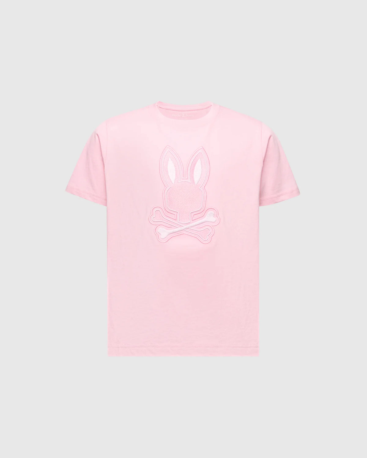 The KIDS NEW CASTLE EMBROIDERED GRAPHIC TEE - B0U415F200 by Psycho Bunny features a pink tee with a bunny head and skull and crossbones embroidery on the chest, all in premium Pima cotton set against a gray background.