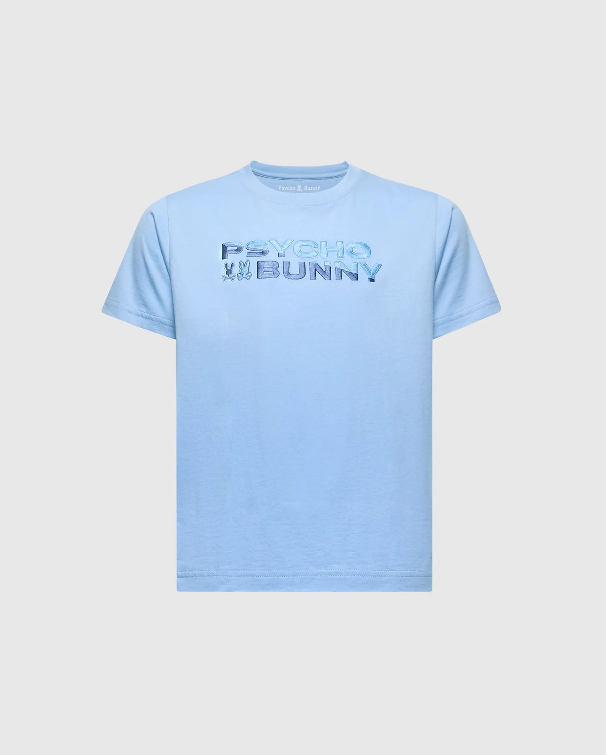 The KIDS BERNI EMBROIDERED WORDMARK GRAPHIC TEE - B0U417F200 by Psycho Bunny is a light blue, regular fit Pima cotton shirt featuring multicolored "Psycho Bunny" text on the front, with an embroidered bunny and crossbones logo on a plain background.