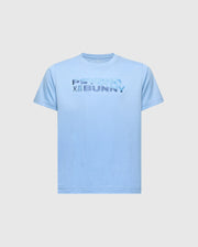 The KIDS BERNI EMBROIDERED WORDMARK GRAPHIC TEE - B0U417F200 by Psycho Bunny is a light blue, regular fit Pima cotton shirt featuring multicolored "Psycho Bunny" text on the front, with an embroidered bunny and crossbones logo on a plain background.