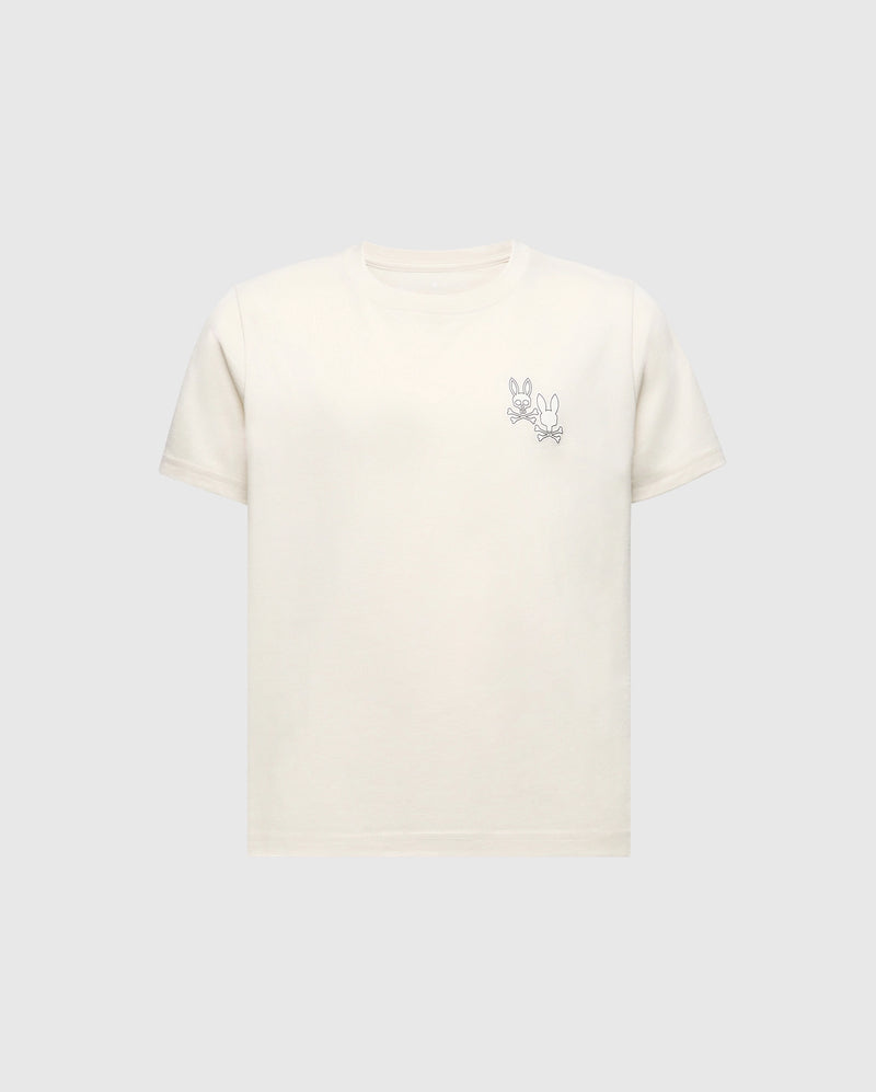 The Psycho Bunny KIDS ELLIOT FRONT BACK GRAPHIC TEE (B0U605F200) is a light beige Pima cotton shirt featuring an eco-friendly water-based print of a simple cartoon rabbit line drawing on the upper left, set against a plain grey background.