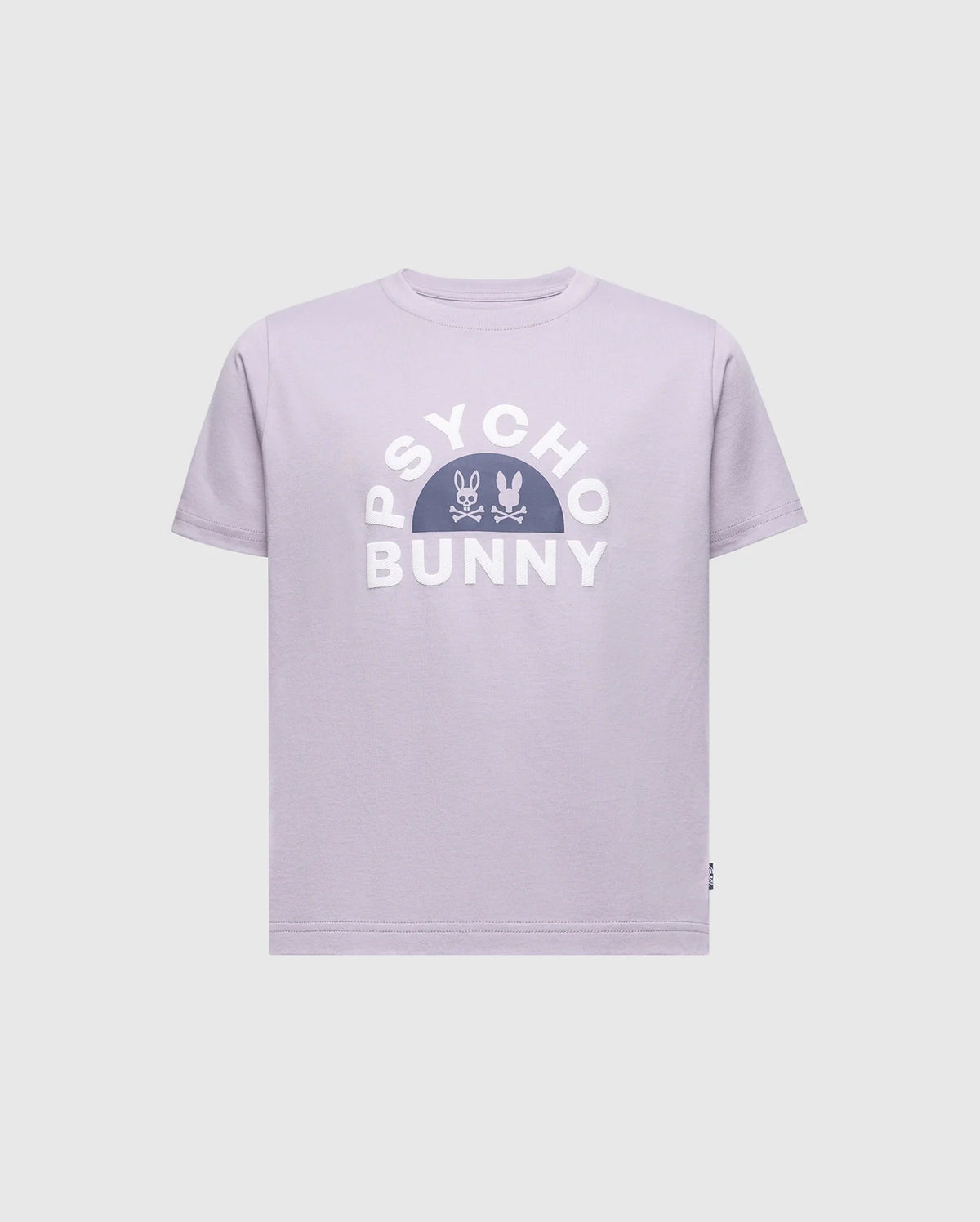 The KIDS GOLDIE GRAPHIC TEE - B0U606F200 by Psycho Bunny showcases a lavender design with bold white "Psycho Bunny" letters, featuring a centered stylized bunny and crossbones. Made from soft Peruvian Pima cotton, it offers a comfortable and relaxed fit.