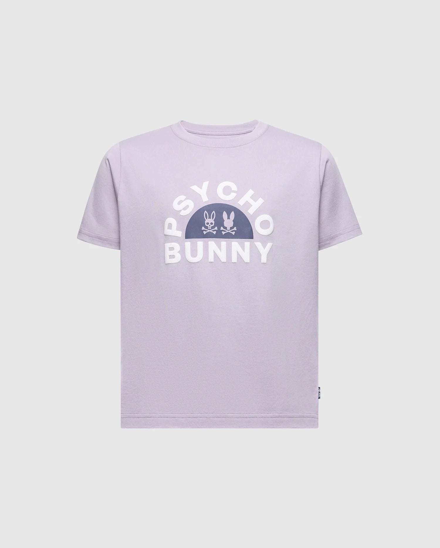 The KIDS GOLDIE GRAPHIC TEE - B0U606F200 by Psycho Bunny showcases a lavender design with bold white "Psycho Bunny" letters, featuring a centered stylized bunny and crossbones. Made from soft Peruvian Pima cotton, it offers a comfortable and relaxed fit.