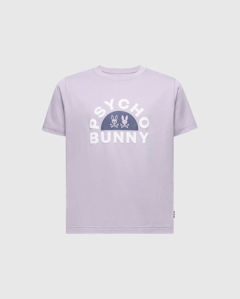 The KIDS GOLDIE GRAPHIC TEE - B0U606F200 by Psycho Bunny showcases a lavender design with bold white "Psycho Bunny" letters, featuring a centered stylized bunny and crossbones. Made from soft Peruvian Pima cotton, it offers a comfortable and relaxed fit.