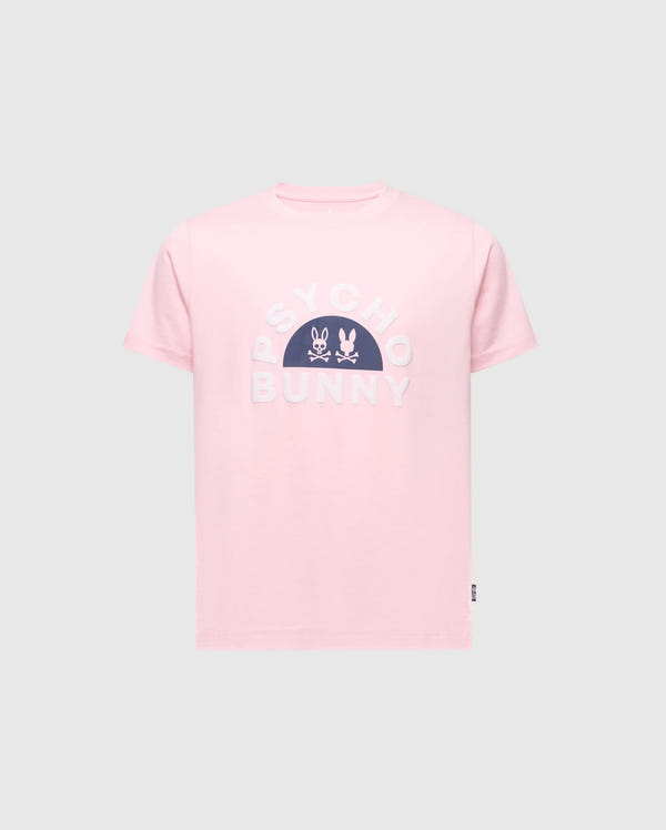The KIDS GOLDIE GRAPHIC TEE - B0U606F200 from Psycho Bunny in pink features bold white "Psycho Bunny" text on the chest, complemented by two unique bunny graphics above. Made from Peruvian Pima cotton, it is presented against a plain backdrop for a striking effect.