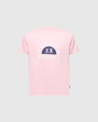 The KIDS GOLDIE GRAPHIC TEE - B0U606F200 from Psycho Bunny in pink features bold white "Psycho Bunny" text on the chest, complemented by two unique bunny graphics above. Made from Peruvian Pima cotton, it is presented against a plain backdrop for a striking effect.