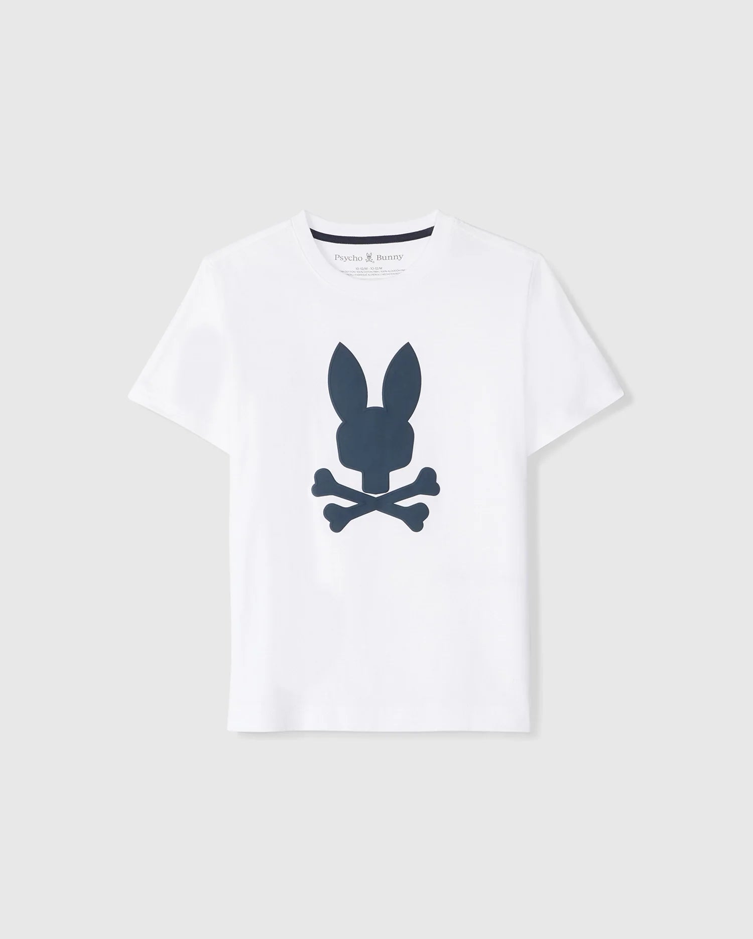 The KIDS HOUSTON GRAPHIC TEE - B0U607C200 by Psycho Bunny is a white, short-sleeve t-shirt for kids made from Pima cotton. It features a dark blue graphic logo on the front, depicting a stylized bunny head above two crossed bones in a skull and crossbones design. The tee is displayed against a plain light gray background.