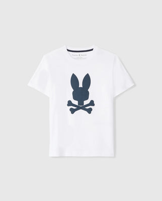 The KIDS HOUSTON GRAPHIC TEE - B0U607C200 by Psycho Bunny is a white, short-sleeve t-shirt for kids made from Pima cotton. It features a dark blue graphic logo on the front, depicting a stylized bunny head above two crossed bones in a skull and crossbones design. The tee is displayed against a plain light gray background.