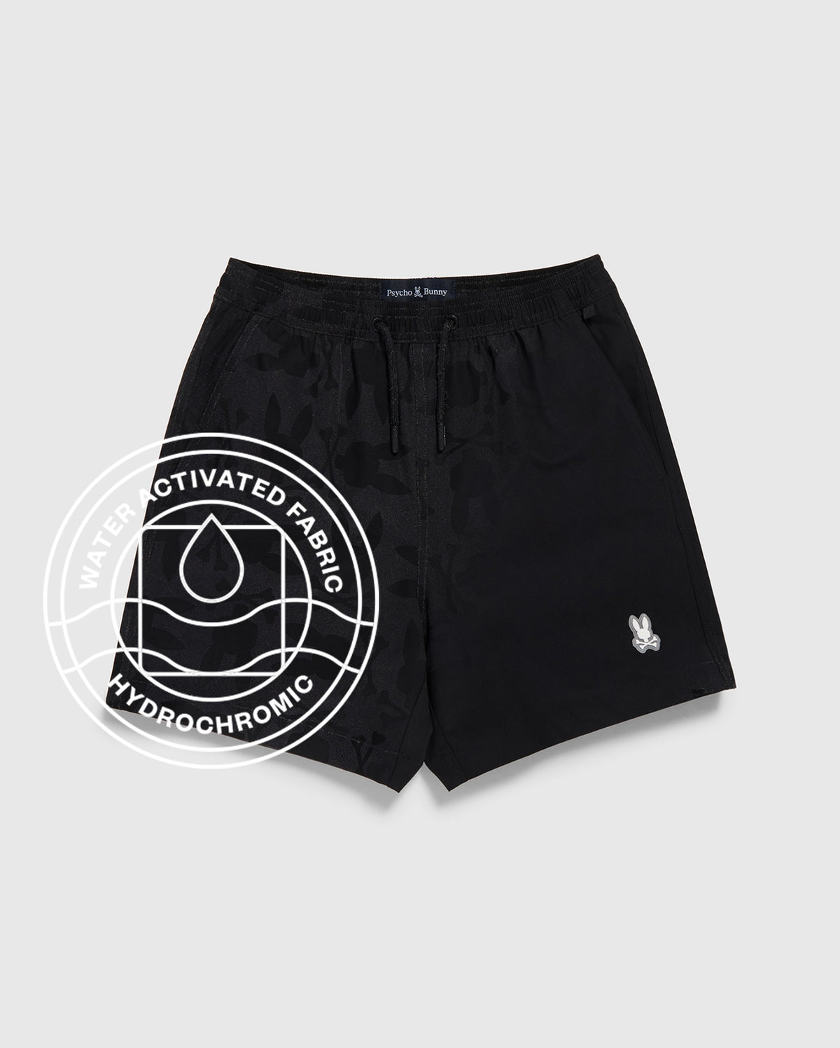 The Psycho Bunny Kids Parker Hydrochromic Swim Trunk (B0W646C200) features a drawstring waist, small white bunny logo, and quick-dry fabric that reveals a unique hydrochromatic pattern when wet.