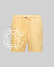 The Psycho Bunny MENS SAMOS HYDROCHROMIC PRINTED SWIM TRUNK (B6W453F200) features a light yellow shade, subtle bunny pattern, drawstring waist, white bunny logo on the left leg, and a "Water Activated Fabric Hydrochromic Technology" label.