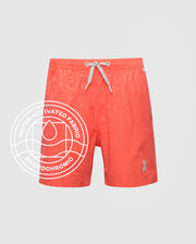 The Psycho Bunny KIDS SAMOS HYDROCHROMIC PRINTED SWIM TRUNK (B0W453F200) features coral quick-dry fabric, a subtle pattern, white drawstring, bunny logo on the left leg, and a water-activated hydrochromic emblem.