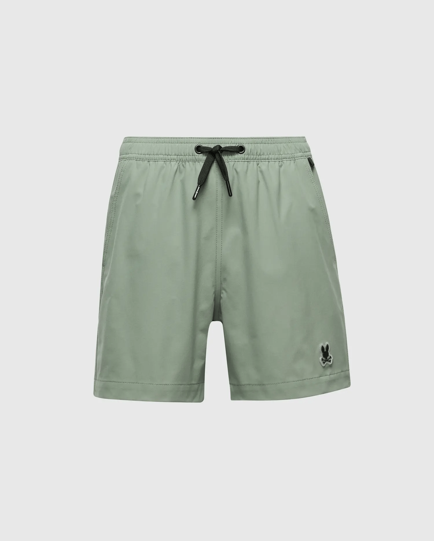 Psycho Bunny's KIDS SAMOS HYDROCHROMIC PRINTED SWIM TRUNK in sage green, featuring a black drawstring and logo, reveals hidden patterns when wet. Inspired by the Samos design, its elastic waistband ensures comfort. Product Code: B0W453F200.