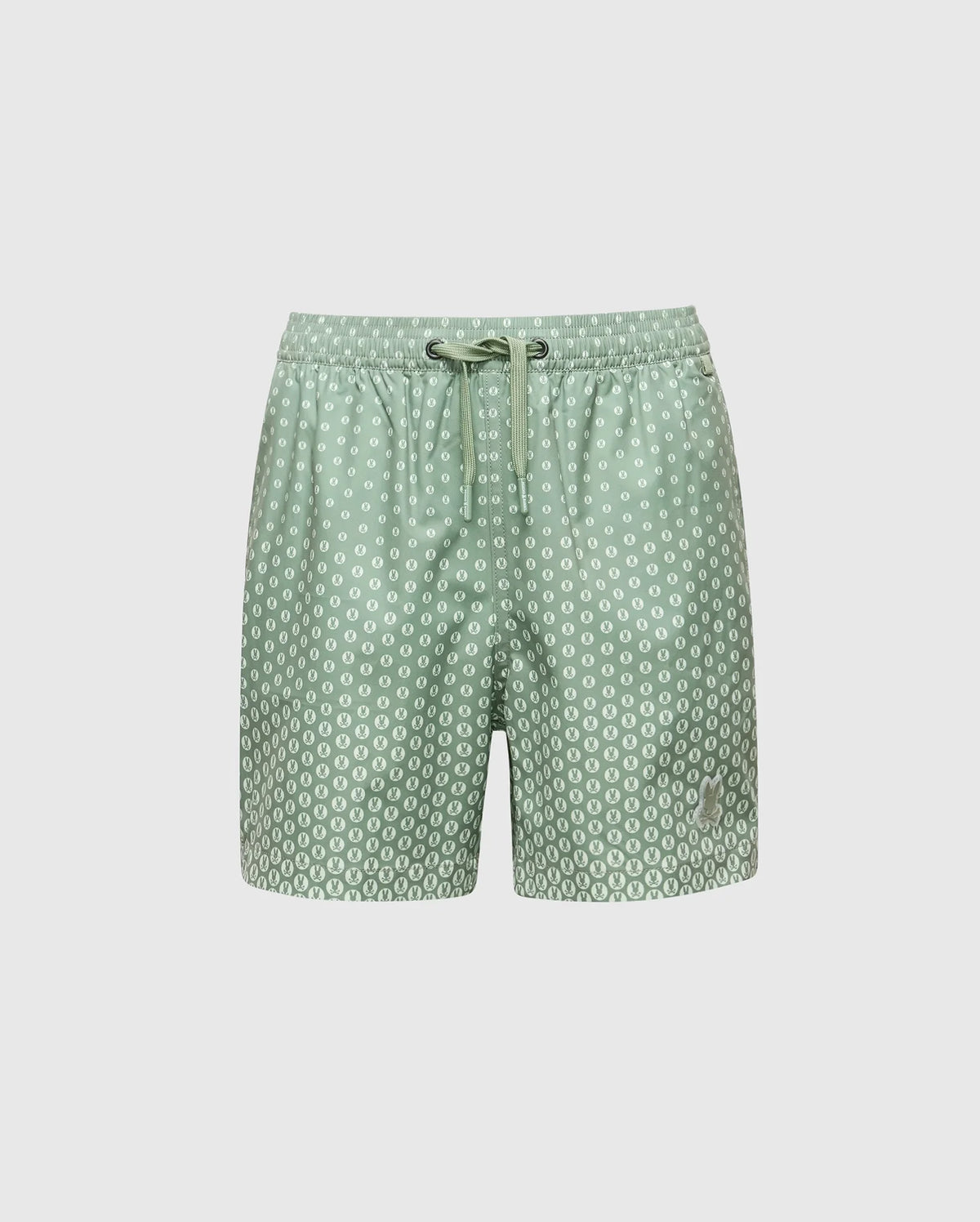 The Psycho Bunny KIDS BENDIGO ALL OVER PRINTED SWIM TRUNK (B0W619F200) features light green quick-dry fabric with white circular dots, an elastic waistband, and a drawstring tie. Displayed on a plain white background.