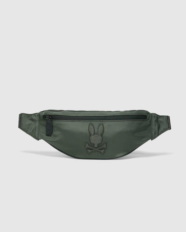 The Psycho Bunny MENS CROSS BODY BAG - B6A181E200 is a green travel bag for men, featuring a top zipper pocket and an embroidered rabbit and crossbones logo on the front. Made from smooth, semi-glossy nylon, it includes an adjustable strap for convenience.