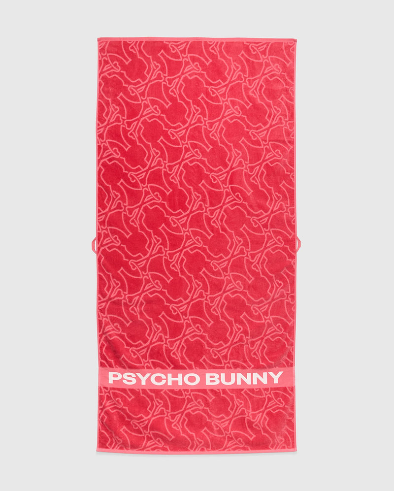 The Psycho Bunny TOWEL - B6A287F200 is a red terrycloth cotton towel with outlined bunny shapes and a solid band displaying bold white "PSYCHO BUNNY" text—ideal for fans of premium style.