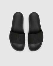 The Psycho Bunny MENS KNIT SLIDES - B6A474F200 are black slide sandals with textured straps and feature a flocked Bunny emblem design. They offer comfort with a molded footbed and are displayed on a plain light grey background.