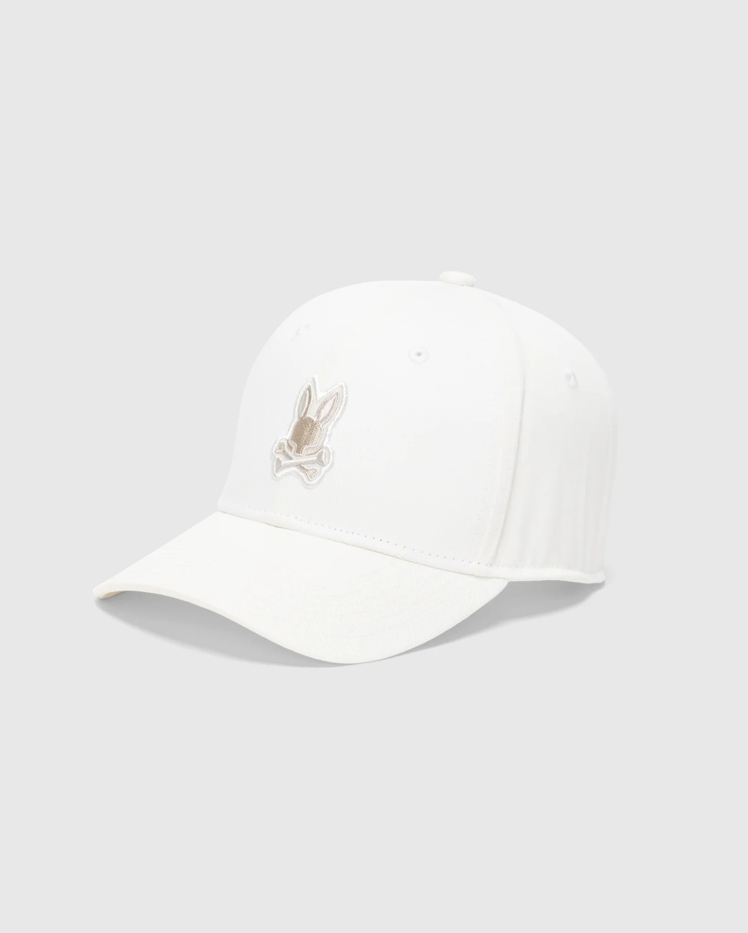 The Psycho Bunny MENS NEW CASTLE EMBROIDERED GRAPHIC BASEBALL CAP - B6A547F200 showcases a beige rabbit embroidery on a white cotton twill, offering an essence of quiet luxury against a plain gray background.