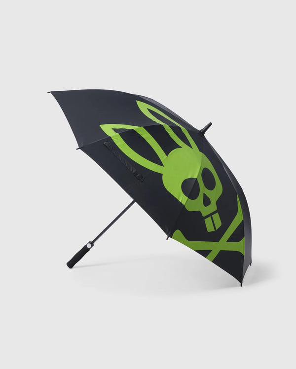 A reliable black umbrella featuring a large green skull with rabbit ears and crossbones design. The Psycho Bunny GOLF UMBRELLA - B6A624C200 is open, showing the pattern prominently. Perfect for die-hard golfers, it has a straight black handle and is positioned on a plain white background.