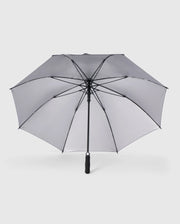 A grey Psycho Bunny GOLF UMBRELLA - B6A624C200 with a black handle and metal ribs is fully open against a plain white background. The umbrella has a classic design and appears sturdy, making it an ideal reliable umbrella for die-hard golfers seeking protection against rain.