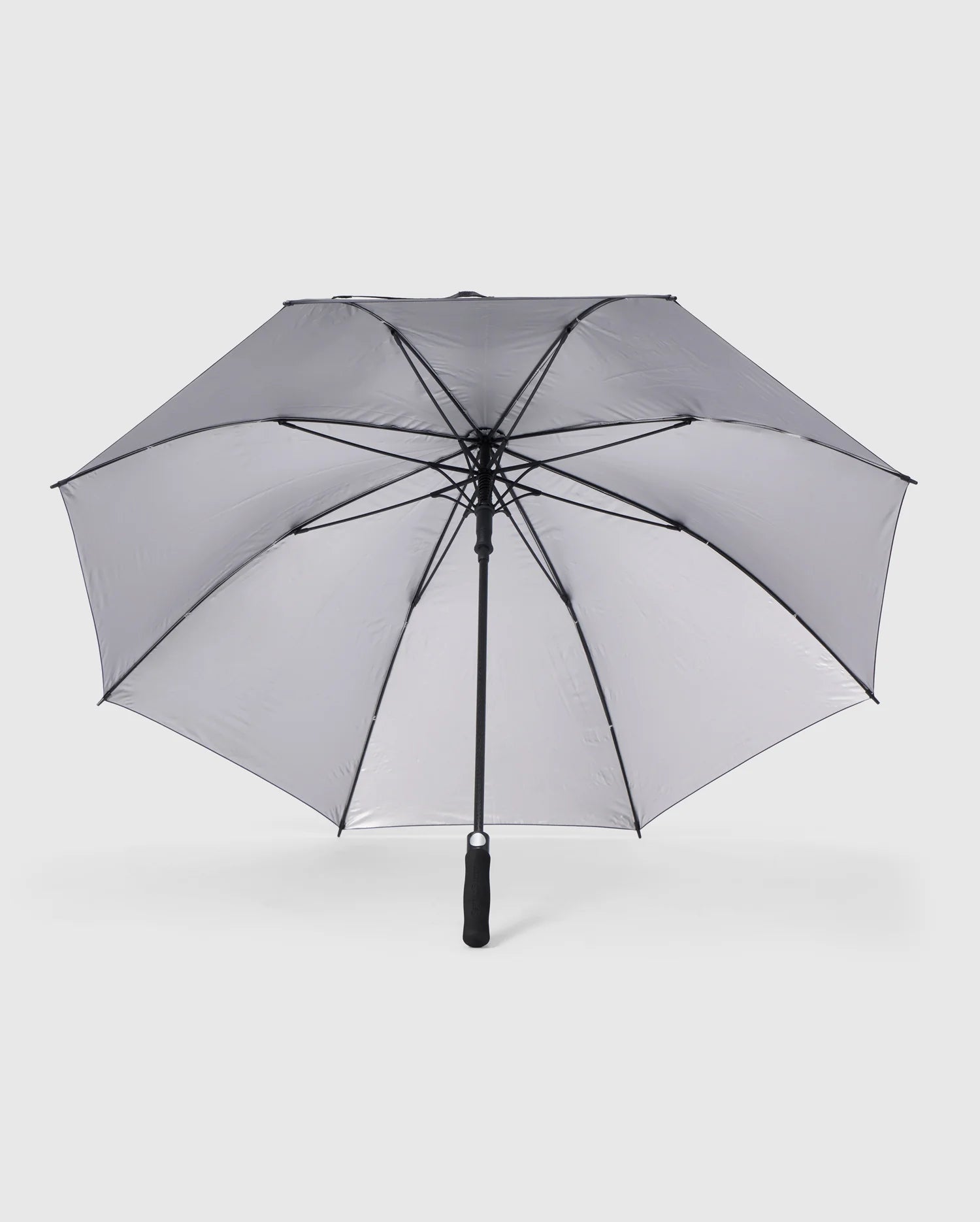 A grey Psycho Bunny GOLF UMBRELLA - B6A624C200 with a black handle and metal ribs is fully open against a plain white background. The umbrella has a classic design and appears sturdy, making it an ideal reliable umbrella for die-hard golfers seeking protection against rain.