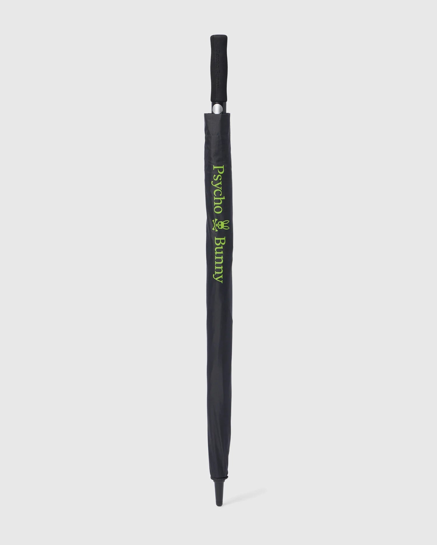 A black GOLF UMBRELLA - B6A624C200 with a protective cover. The cover features the text "Psycho Bunny" and a small bunny logo in green, vertically aligned along the length of this reliable umbrella. The handle is black with a grip texture. The umbrella is standing upright against a white background.