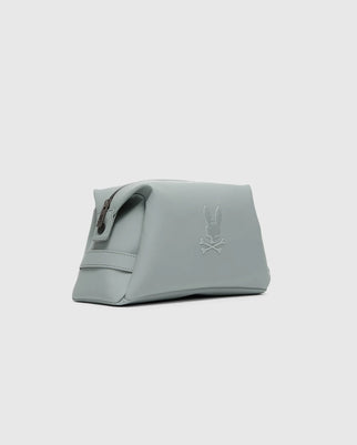 The Psycho Bunny MENS RUBBERIZED TOILETRY KIT (B6A189E200) is a light gray polyester bag with a zipper and embossed rabbit and crossbones logo—stylish, practical, and perfect for organizing essentials on the go.