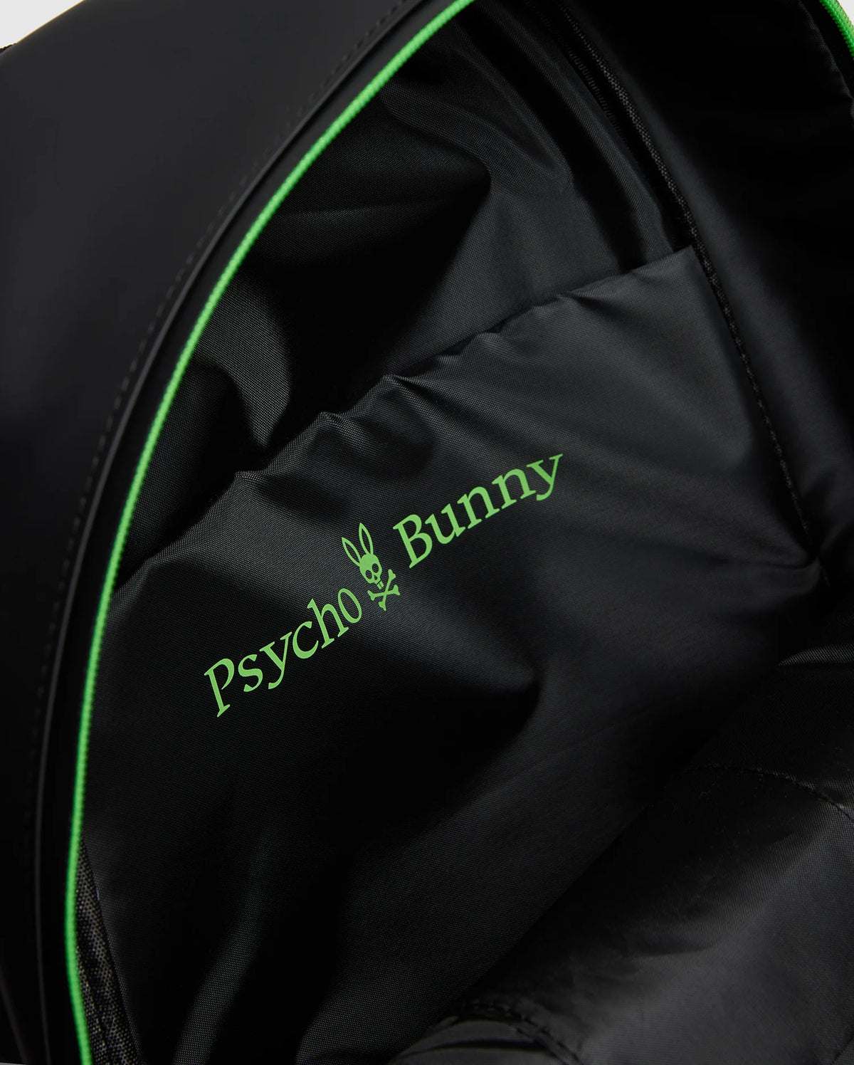 Close-up of a MENS RUBBERIZED BACKPACK - B6A637F200 interior featuring the green Psycho Bunny logo with a bunny skull design. The durable lining shows off its smooth fabric and subtle stitching, highlighting its functionality.