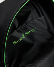 Close-up of a MENS RUBBERIZED BACKPACK - B6A637F200 interior featuring the green Psycho Bunny logo with a bunny skull design. The durable lining shows off its smooth fabric and subtle stitching, highlighting its functionality.
