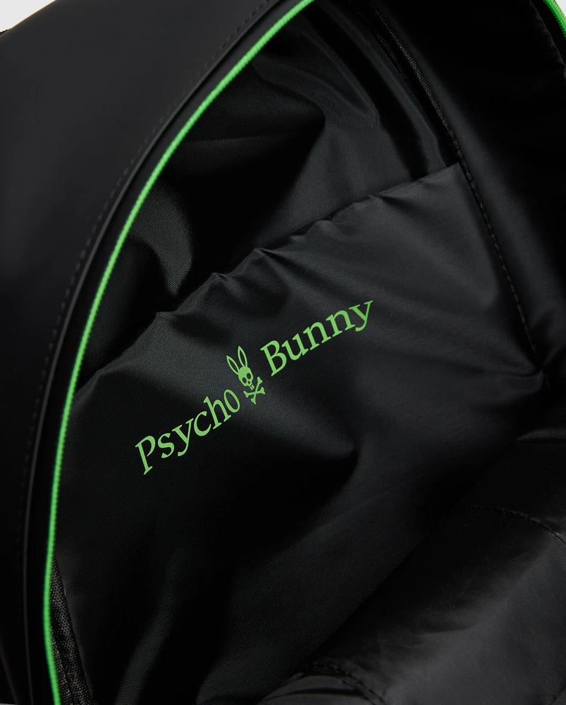 Close-up of a MENS RUBBERIZED BACKPACK - B6A637F200 interior featuring the green Psycho Bunny logo with a bunny skull design. The durable lining shows off its smooth fabric and subtle stitching, highlighting its functionality.