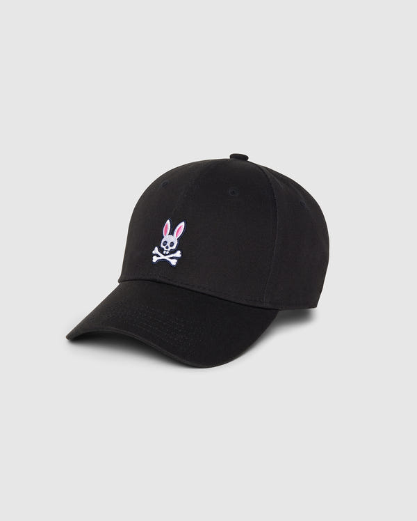 The Psycho Bunny Men's Classic Baseball Cap (B6A816A1HT) is crafted from 100% cotton in classic black, featuring their iconic pink and white embroidered Bunny logo with crossbones on the front. This cap includes a curved brim, six panels with eyelets for ventilation, all set against a simple white background.

