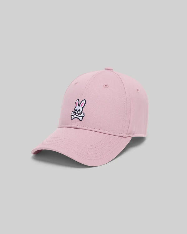 The Psycho Bunny MENS CLASSIC BASEBALL CAP (B6A816A1HT) is a light pink cotton hat with an embroidered white bunny and crossbones on the front. It features an adjustable fit and is shown against a plain gray background.