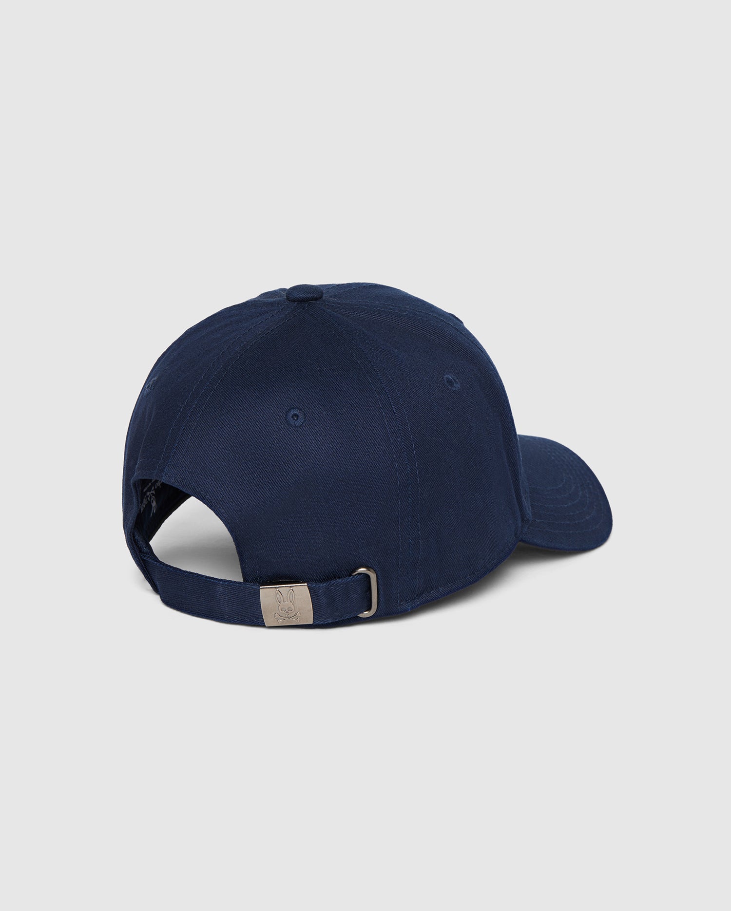 A navy blue MENS CLASSIC BASEBALL CAP - B6A816A1HT by Psycho Bunny with a curved brim is shown from the back. Made of durable cotton twill, it has an adjustable strap with a metal clasp for sizing. The classic men's accessory features a simple, unadorned design.