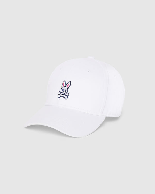 The Psycho Bunny MENS CLASSIC BASEBALL CAP - B6A816A1HT, in a classic white color, showcases an embroidered design featuring a cartoonish rabbit's head with pink ears and a skull motif, placed above a pair of crossbones on the front. Its adjustable fit ensures comfort, making this cap perfect for everyday wear against its plain light grey background.