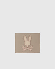 The MENS LEATHER WALLET - B6A868D200 by Psycho Bunny features a stitched bunny head over crossed bones on its light gray front. Its premium leather and unique design make it a luxurious accessory for the discerning.